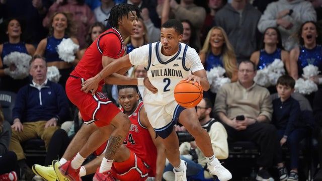Villanova's Jhamir Brickus, right, tries to get past St. John's Simeon Wilcher during the second half of an NCAA college basketball game 