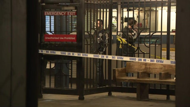 Crime scene tape blocks off part of a subway station platform 