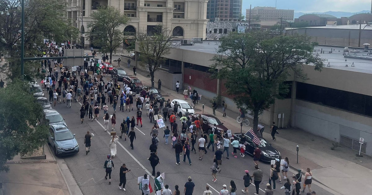 Rallyers demonstrating against ICE arrests march down Denver street 